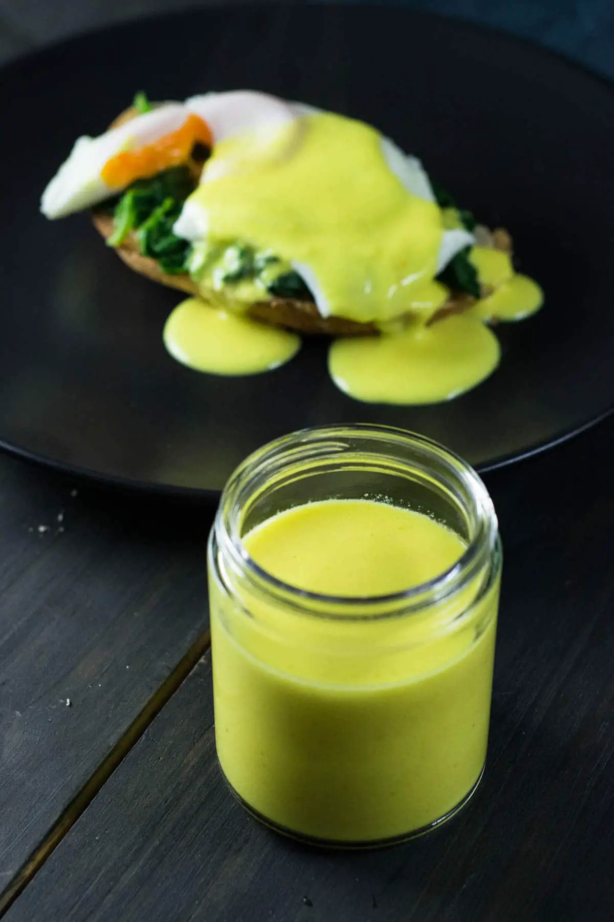healthy mock hollandaise sauce with eggs florentine on the background