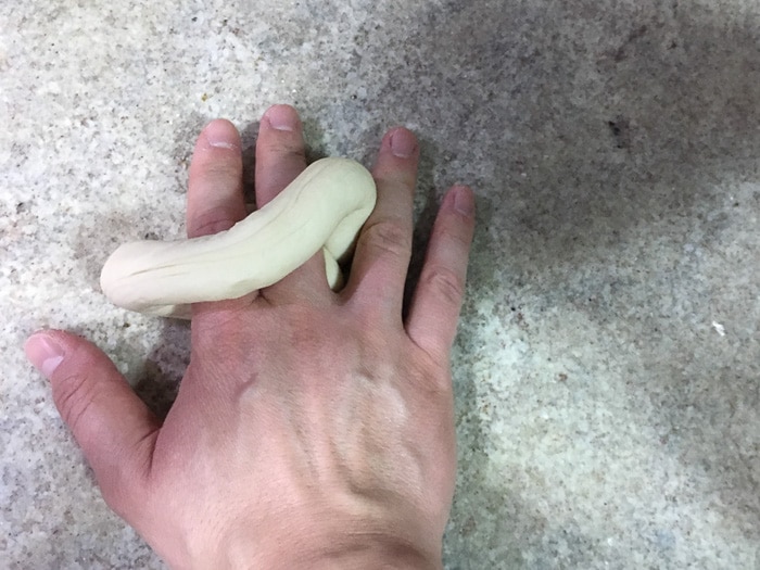 Place two fingers inside dough circle and gently press to seal ends