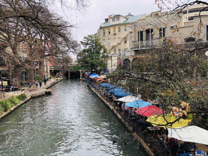 San Antonio Riverwalk with colored umbrellas on the right margin
