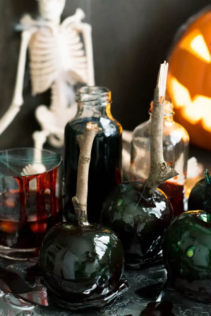 Candy Apple for Halloween - Poison Apples, arranged in front of glass with fake blood and other spooky decorations